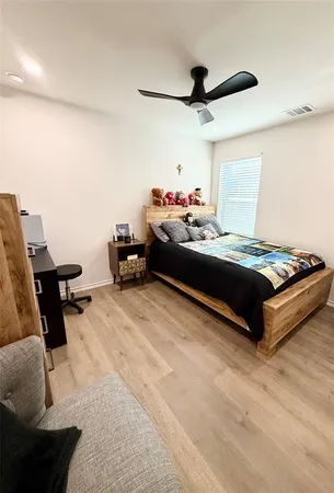 a bed room with a bed and a chair