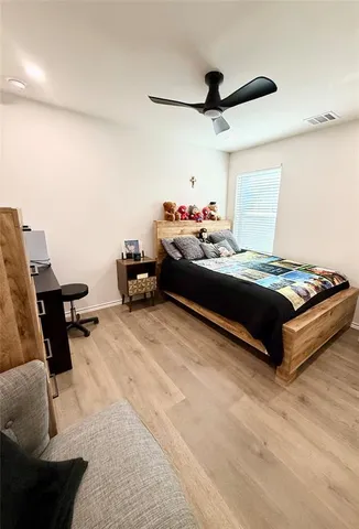 a bed room with a bed and a chair