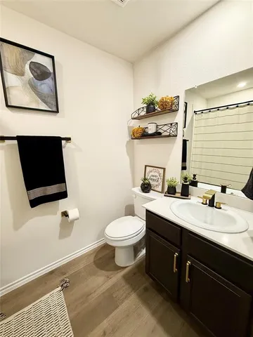 a bathroom with a toilet a sink and mirror