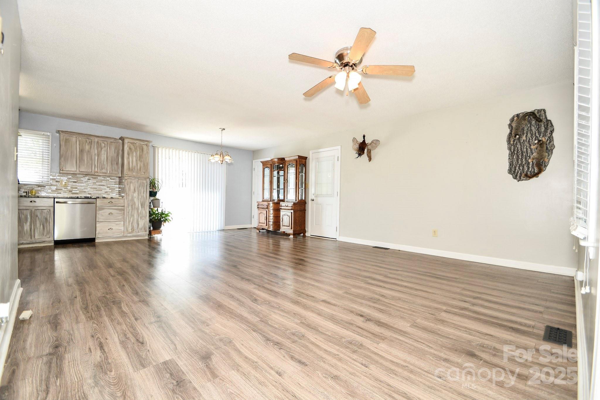 5112 Unionville Road Monroe, NC 28110 - Photo 16 of 31 a view of empty room with wooden floor and kitchen
