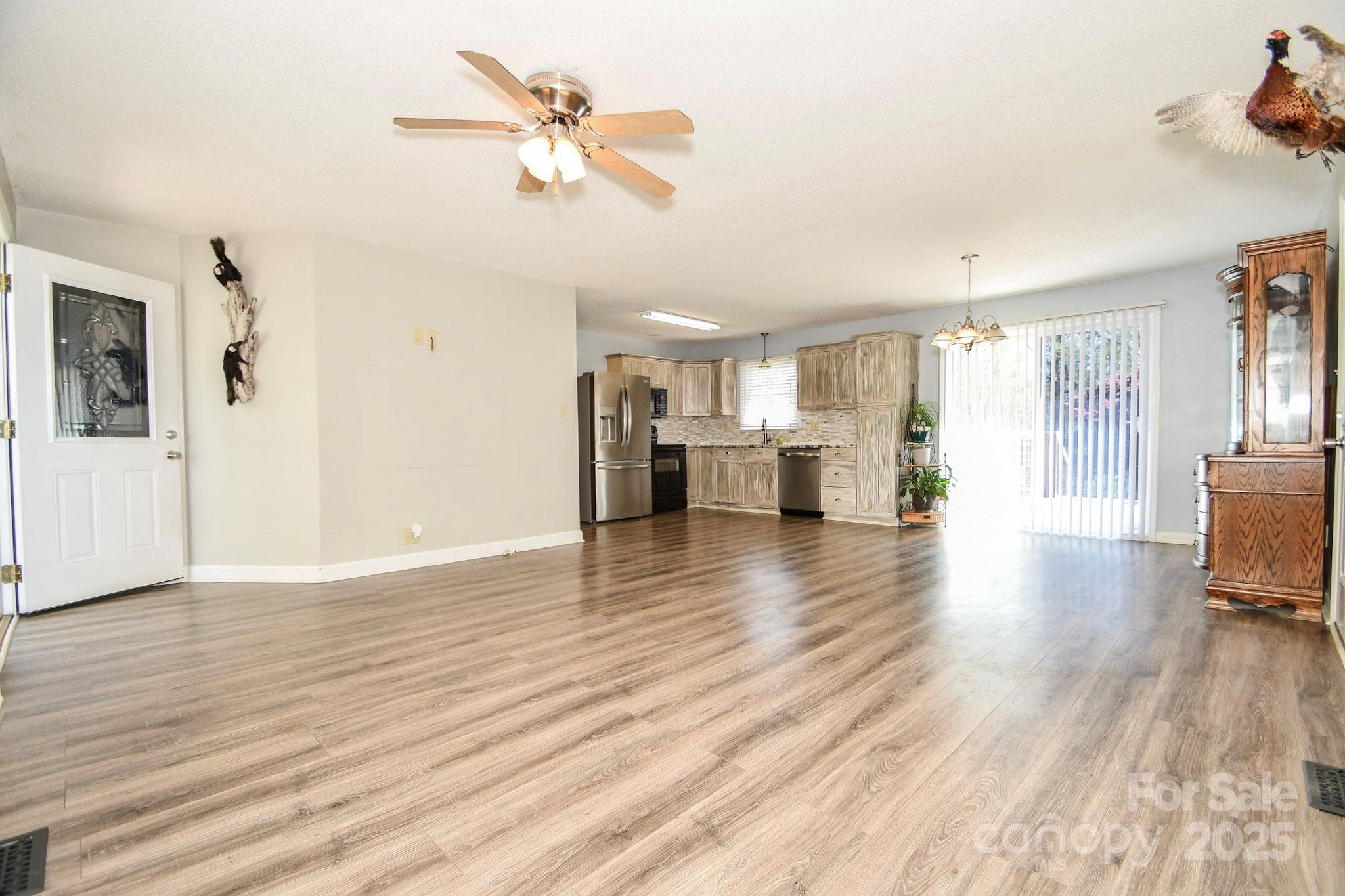 5112 Unionville Road Monroe, NC 28110 - Photo 17 of 31 a view of a livingroom with furniture a ceiling fan and wooden floor