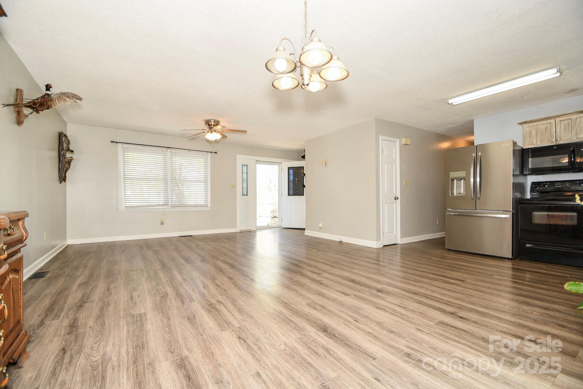 5112 Unionville Road Monroe, NC 28110 - Photo 18 of 31 a view of a kitchen with wooden floor and a ceiling fan