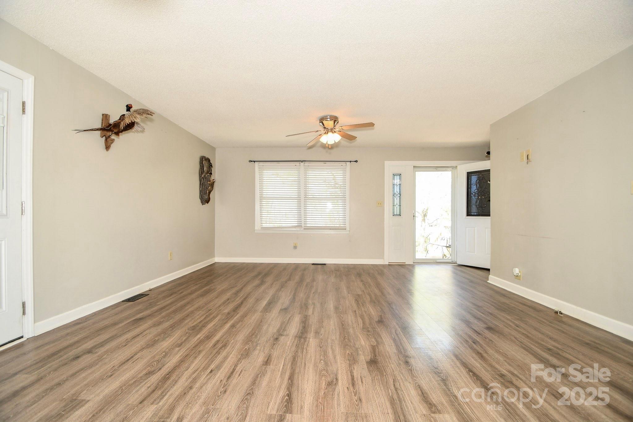 5112 Unionville Road Monroe, NC 28110 - Photo 19 of 31 an empty room with wooden floor and windows