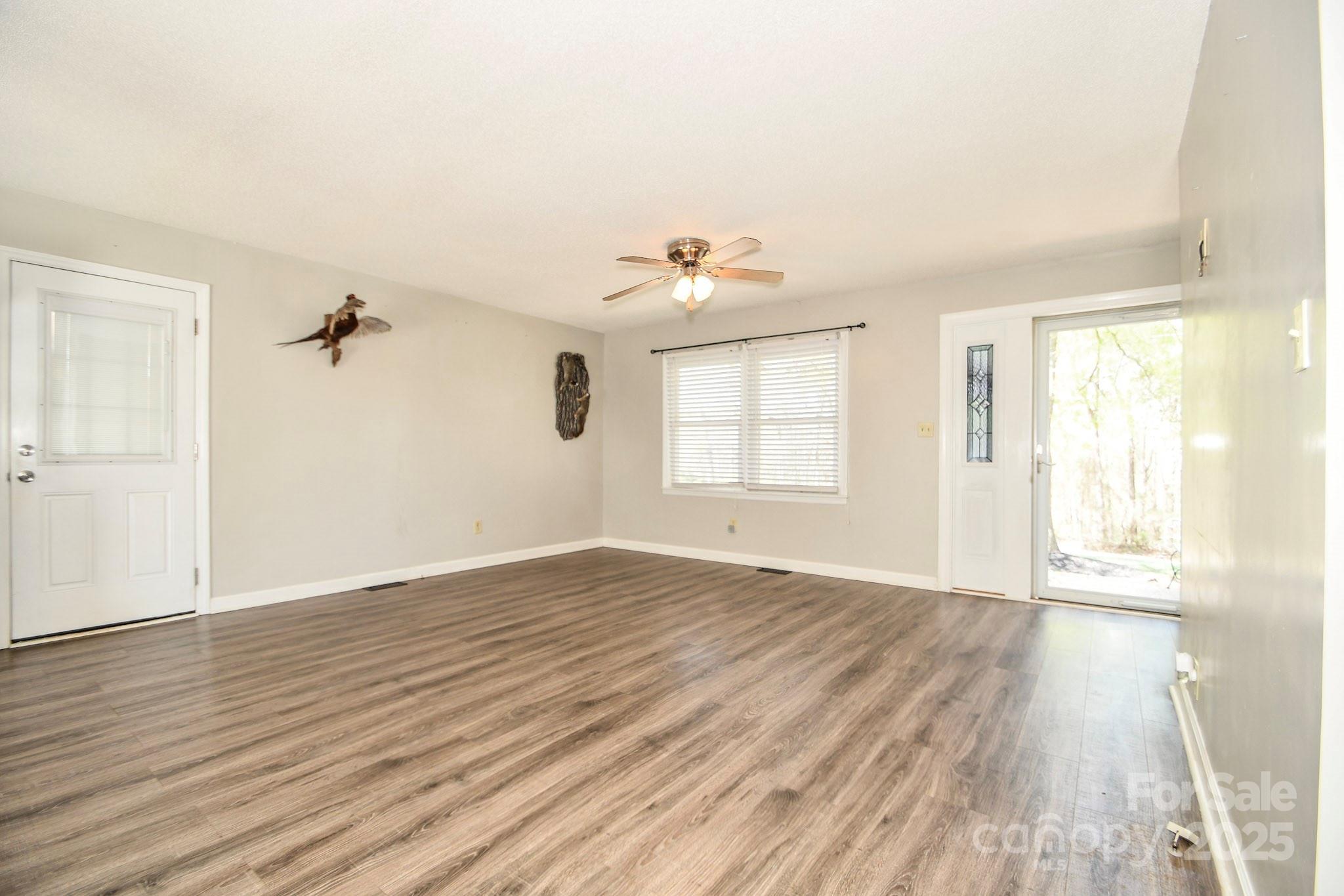 5112 Unionville Road Monroe, NC 28110 - Photo 20 of 31 an empty room with wooden floor and windows