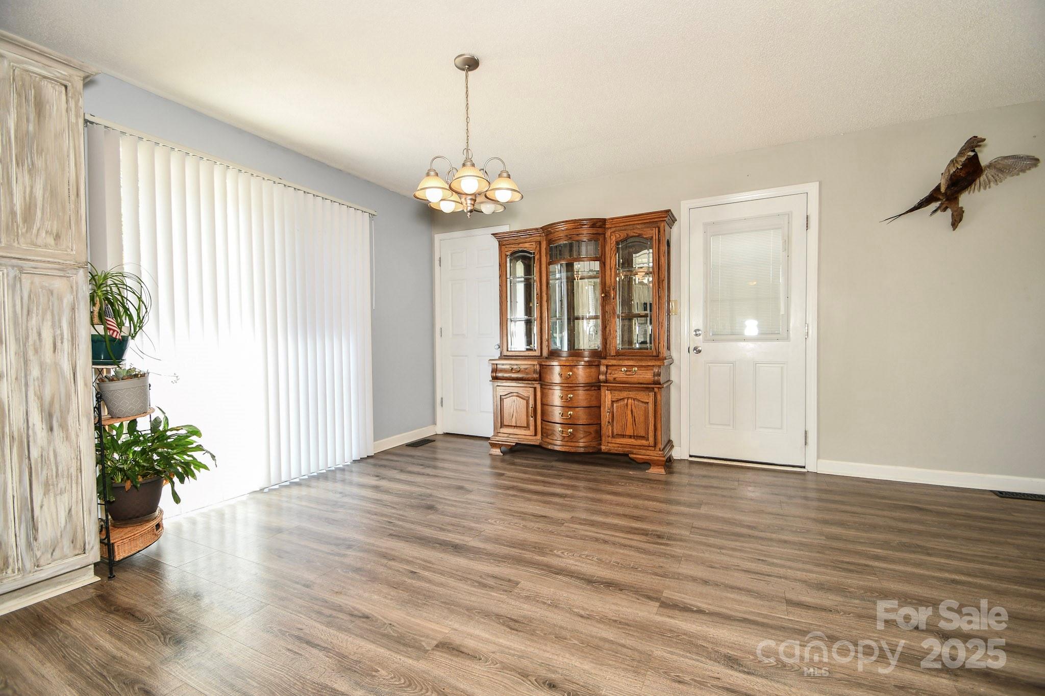 5112 Unionville Road Monroe, NC 28110 - Photo 21 of 31 a view of an empty room with window and wooden floor