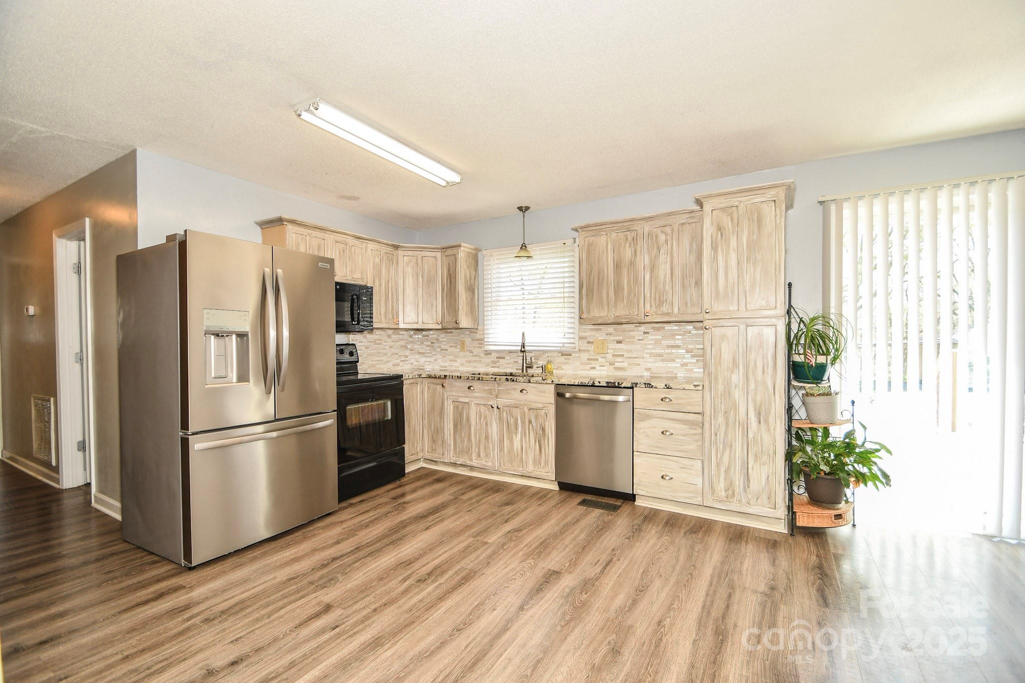 5112 Unionville Road Monroe, NC 28110 - Photo 22 of 31 a kitchen with stainless steel appliances a refrigerator sink and white cabinets