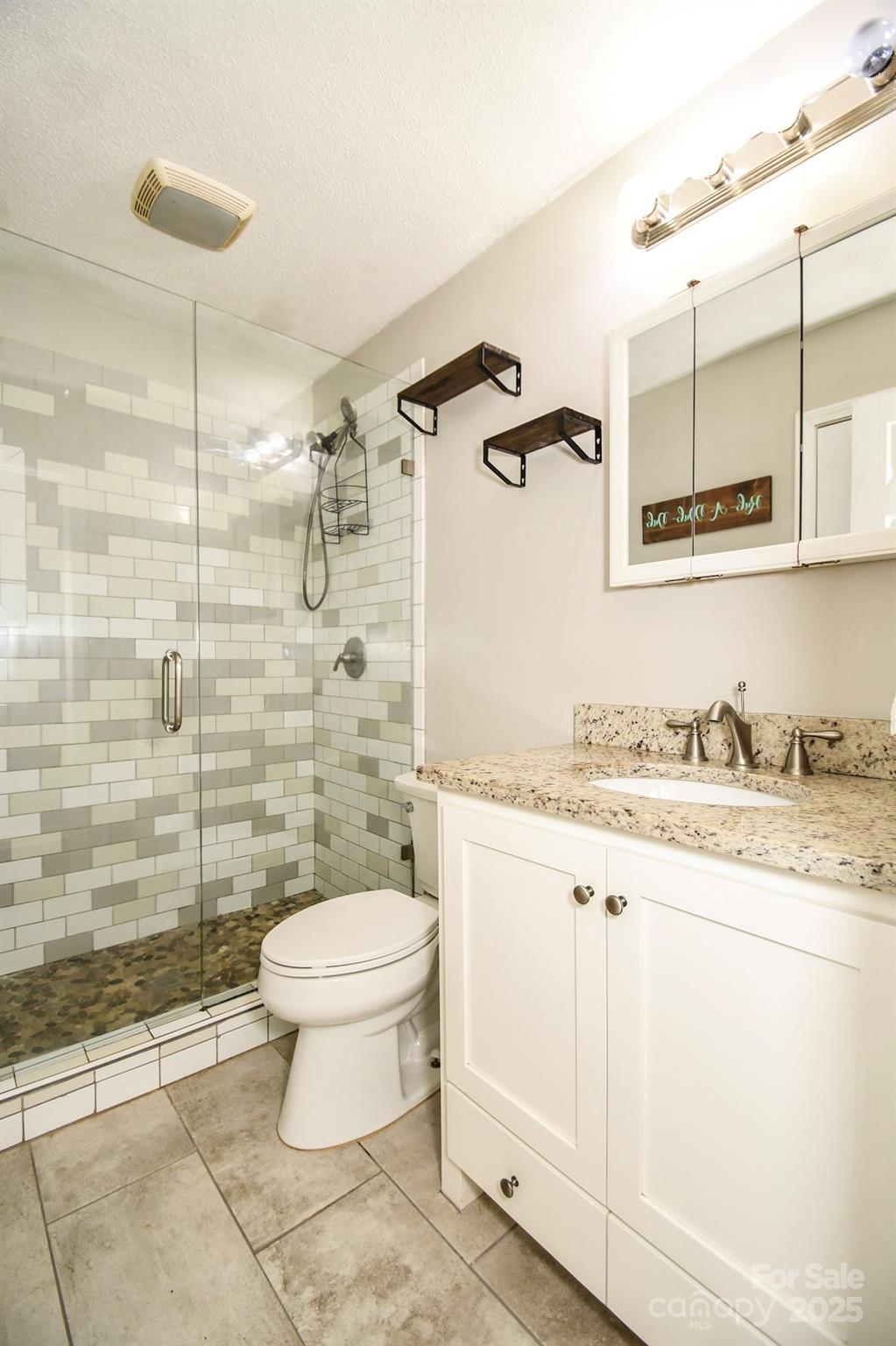 5112 Unionville Road Monroe, NC 28110 - Photo 23 of 31 a bathroom with a granite countertop toilet sink and mirror