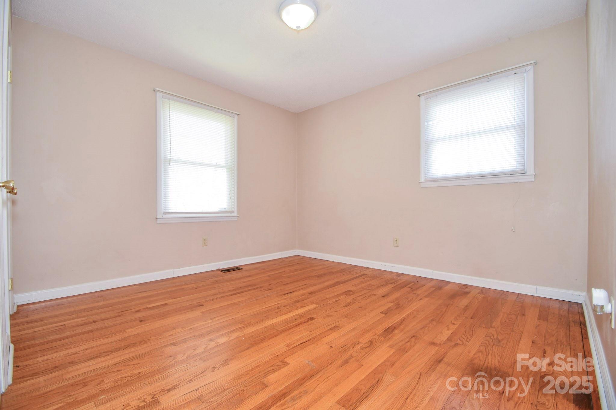 5112 Unionville Road Monroe, NC 28110 - Photo 25 of 31 an empty room with wooden floor and windows