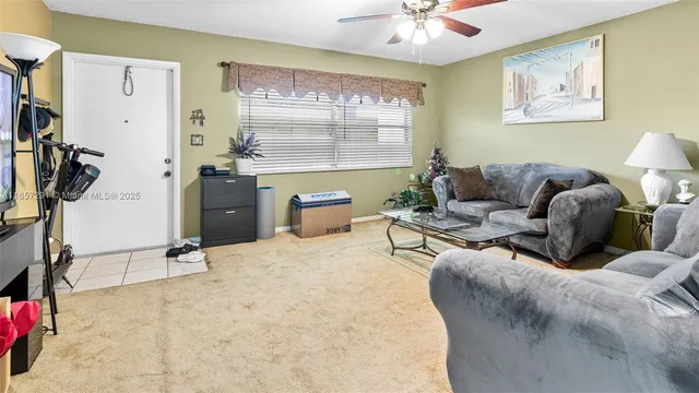 a living room with furniture a window and a flat screen tv