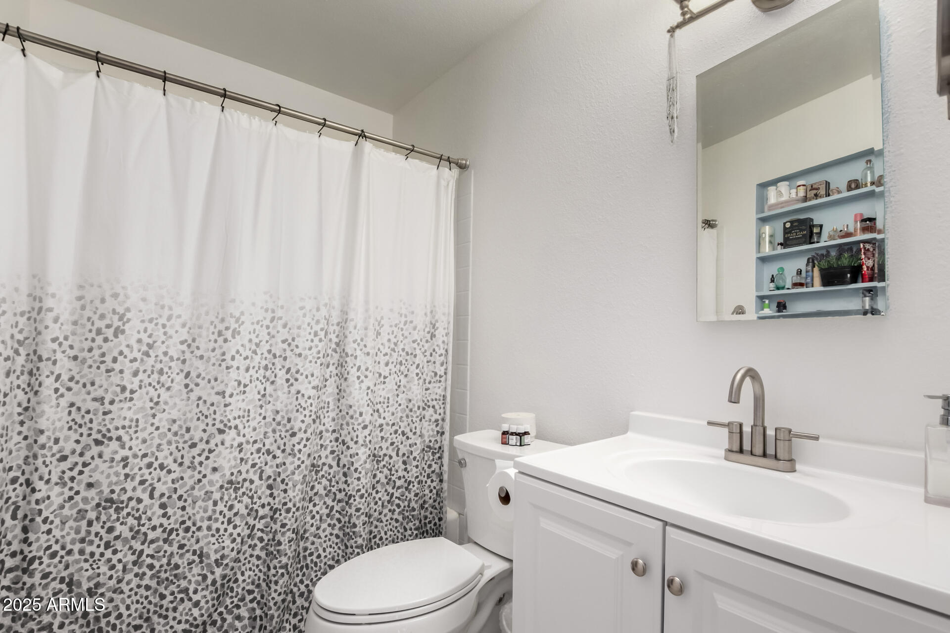 433 East Taylor Street Tempe, AZ 85288 - Photo 15 of 32 a bathroom with a sink a toilet and shower curtain