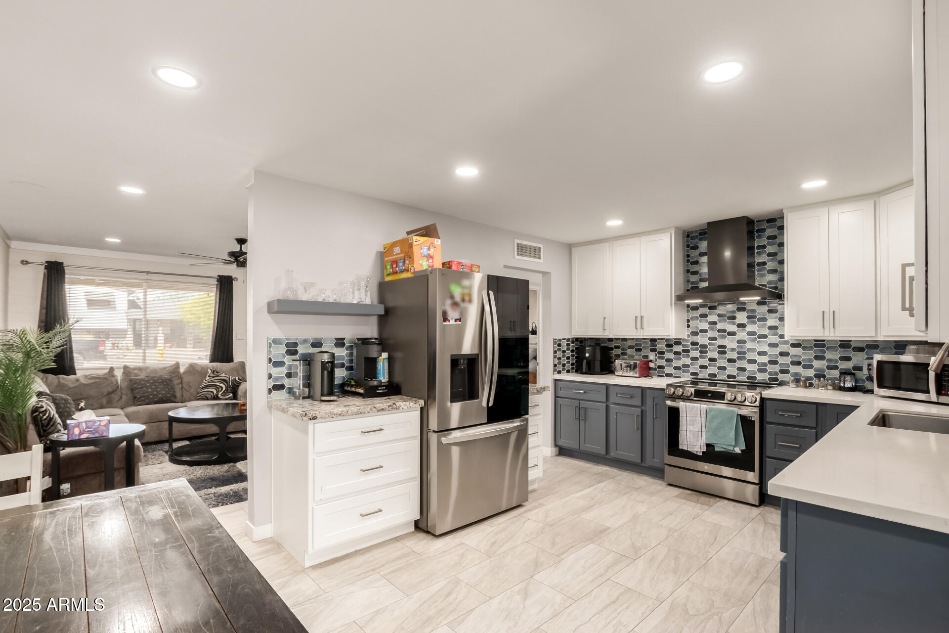 433 East Taylor Street Tempe, AZ 85288 - Photo 10 of 32 a kitchen with stainless steel appliances kitchen island granite countertop a stove refrigerator and cabinets