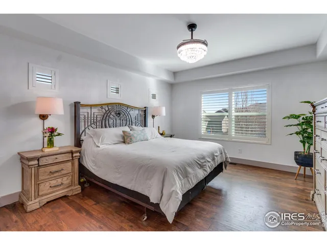 a bedroom with a bed and a potted plant