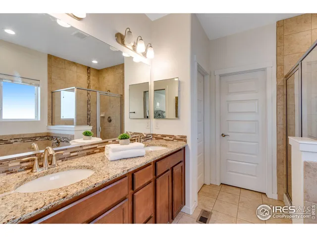 a bathroom with a granite countertop sink mirror and