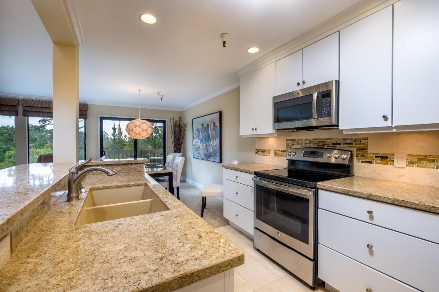 37 Shepherds Knoll Road Monterey, CA 93940 - Photo 11 of 20 a kitchen with kitchen island granite countertop a sink a counter top space appliances and cabinets
