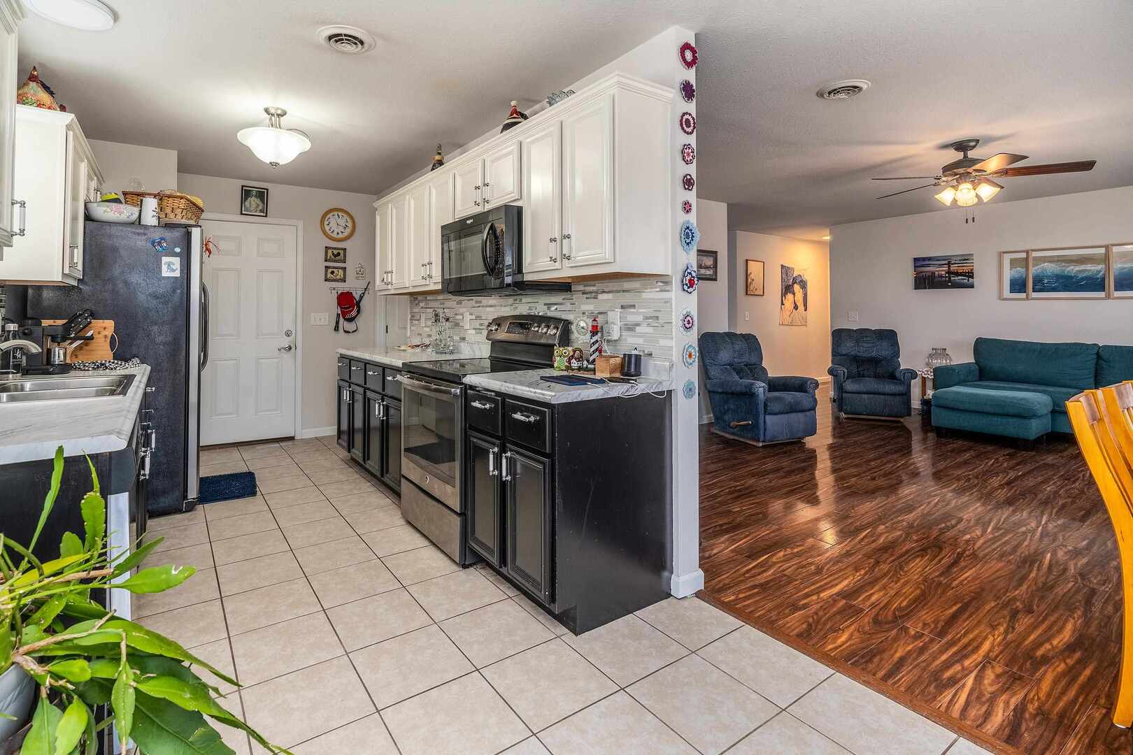 11114 Zachary Drive Marion, IL 62959 - Photo 9 of 34 a kitchen with stainless steel appliances granite countertop a refrigerator a stove top oven a sink dishwasher and white cabinets with wooden floor