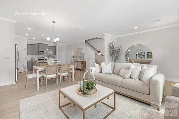 a living room with furniture kitchen and a table