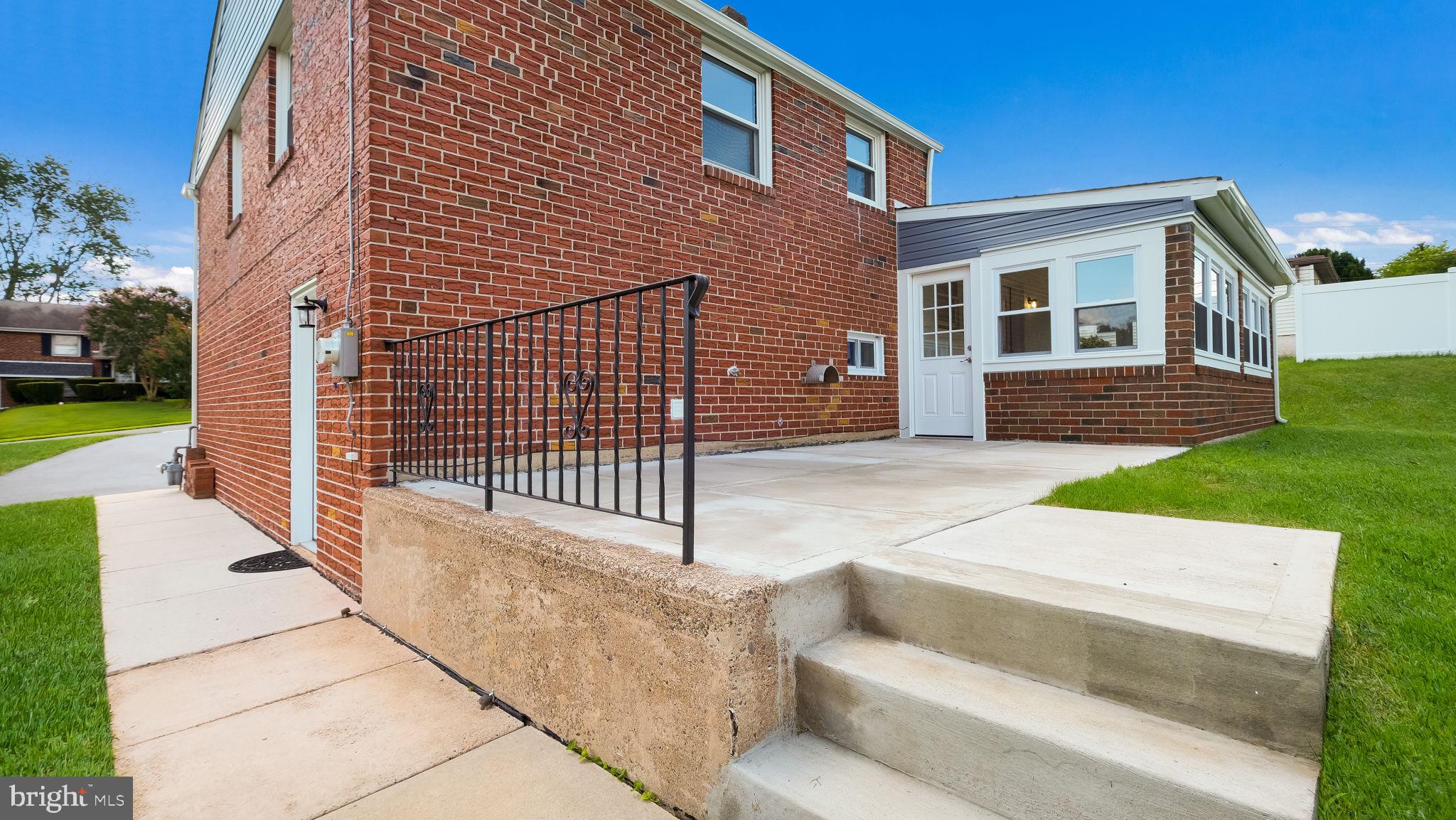 612 Cambridge Road Brookhaven, PA 19015 - Photo 5 of 57 New concrete patio with entrance to sunroom