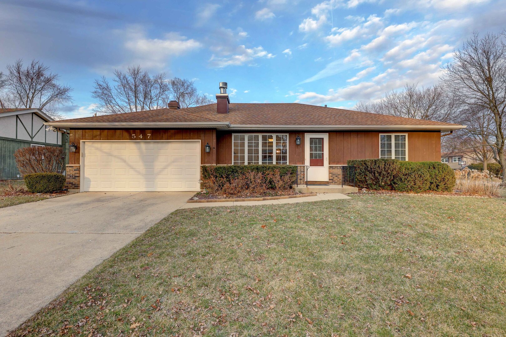 a front view of a house with garden