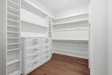 a view of walk in closet with empty racks