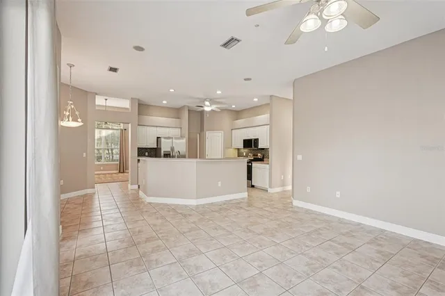 a bathroom with a granite countertop sink a mirror a bathtub and next to a window
