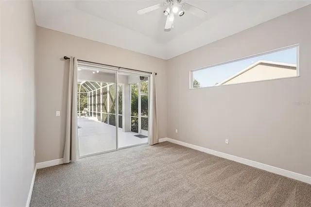 an empty room with a chandelier fan and closet