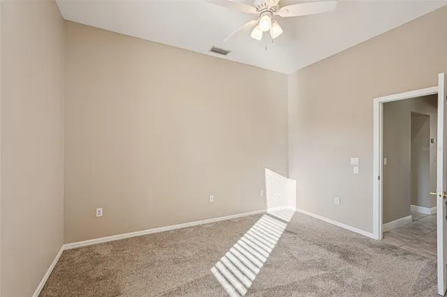 a view of a patio with couches table chairs and wooden floor
