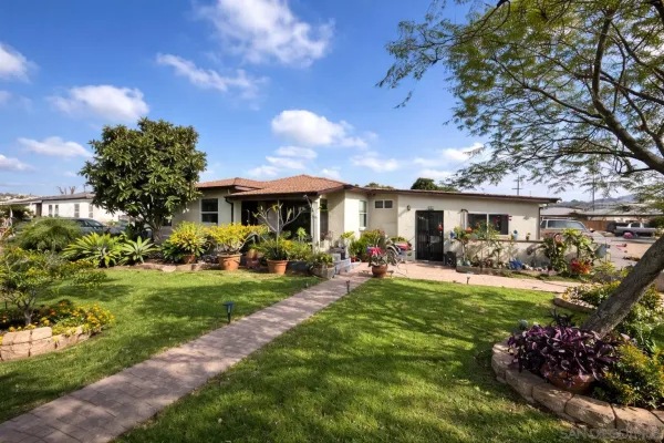 a front view of a house with a garden and porch