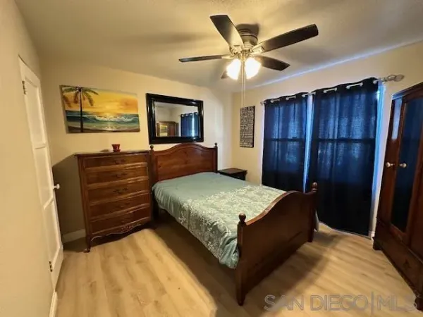 a bedroom with a bed and a dresser
