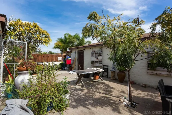 a view of a house with backyard sitting area and garden