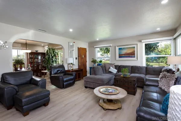a living room with furniture and a wooden floor