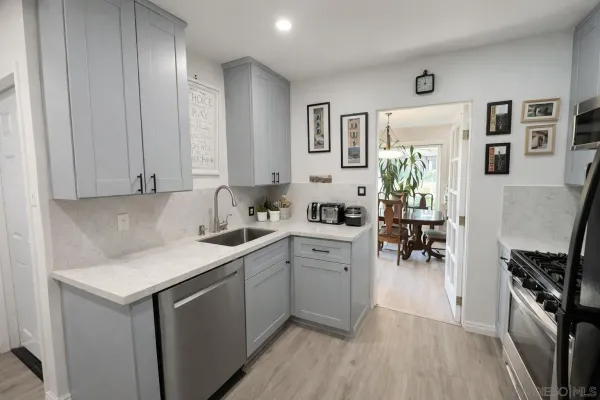 a kitchen with a sink cabinets and wooden floor