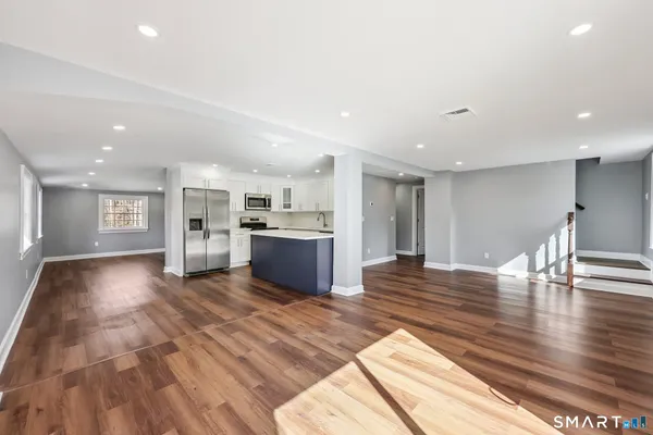 a view of kitchen with granite countertop cabinets and wooden floor