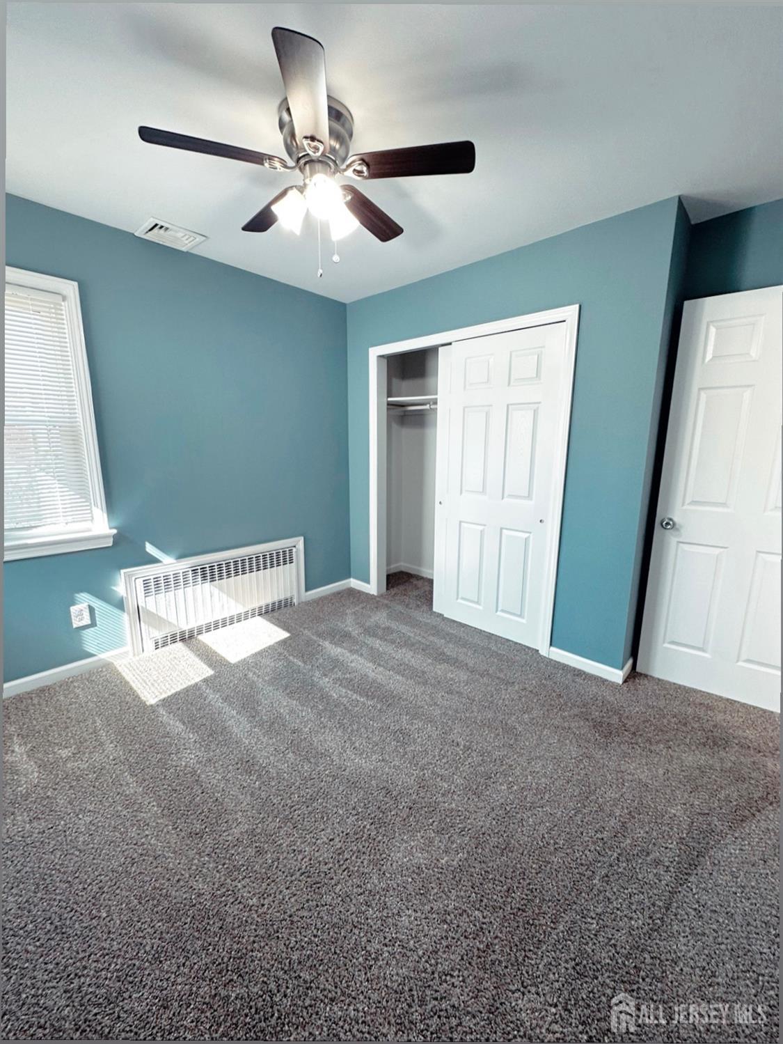 32 Apple Street Edison, NJ 08817 - Photo 4 of 11 a view of a livingroom with a ceiling fan and window