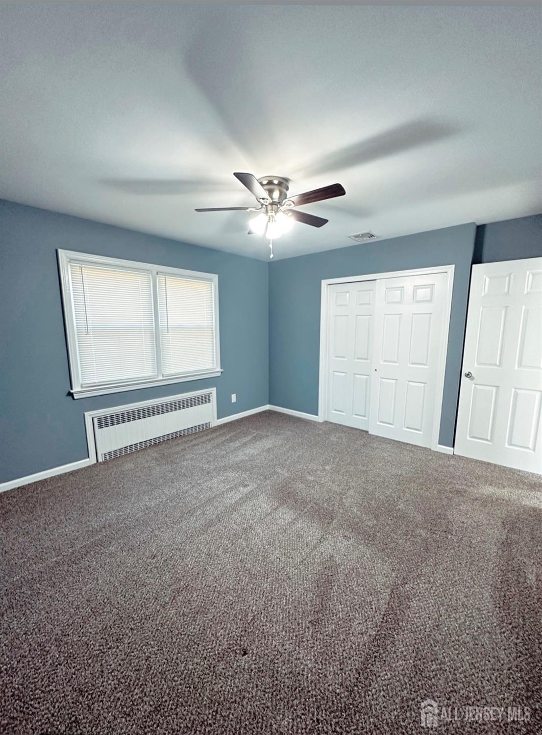 32 Apple Street Edison, NJ 08817 - Photo 5 of 11 a view of an empty room with a window