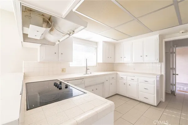a kitchen with cabinets appliances and a sink