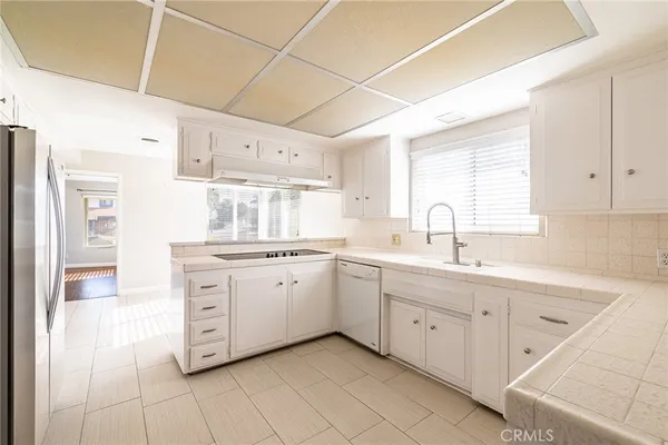 a kitchen with sink cabinets and window