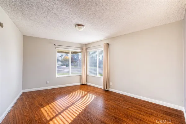a view of a room with wooden floor and window