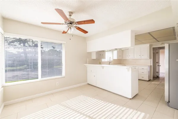 a view of a kitchen with a sink hardwood floor and a window