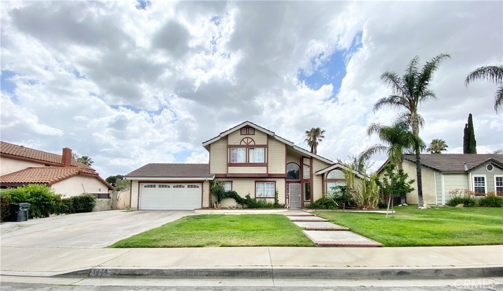 1444 North Sage Avenue Rialto, CA 92376 - Photo 21 of 22 a front view of a house with a yard and garage