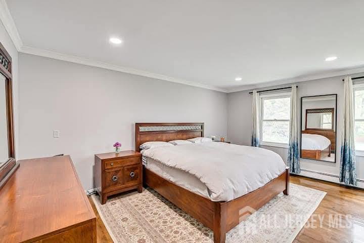 3993 Park Avenue Edison, NJ 08820 - Photo 16 of 37 a bed sitting in a bedroom next to a window