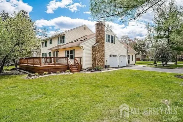 a view of a house with a yard patio and fire pit