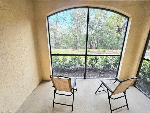 a view of a room with chairs and outside view