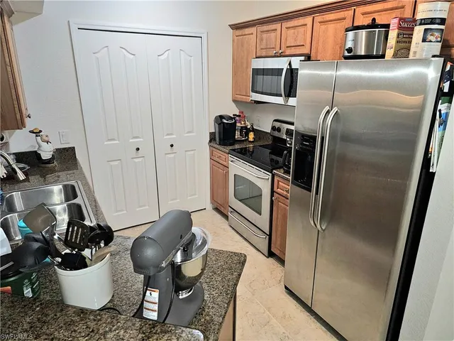 a kitchen with a refrigerator and a sink