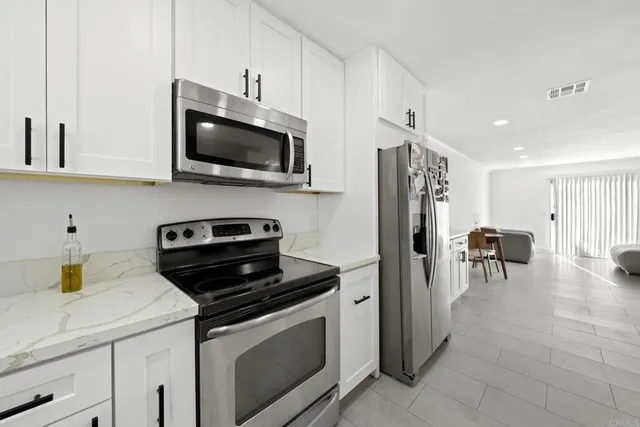 a kitchen with stainless steel appliances a stove microwave and a refrigerator