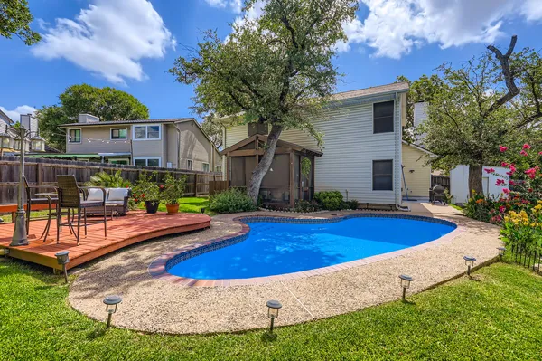 a view of a house with swimming pool and sitting area