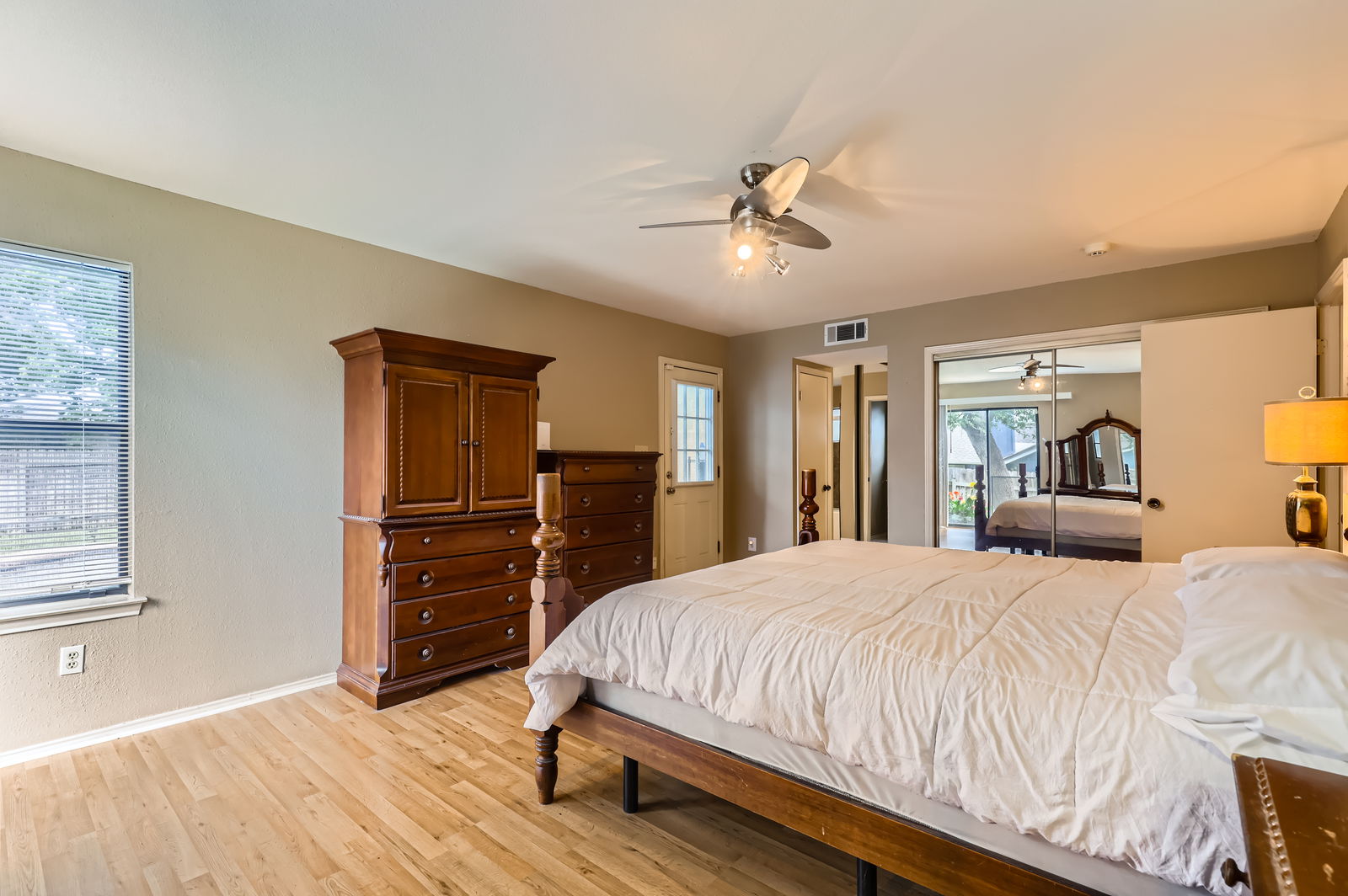 4513 Sidereal Drive Austin, TX 78727 - Photo 18 of 38 a bedroom with a bed and wooden floor