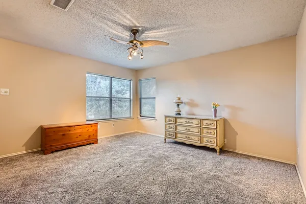 a bed sitting in a bedroom next to a window