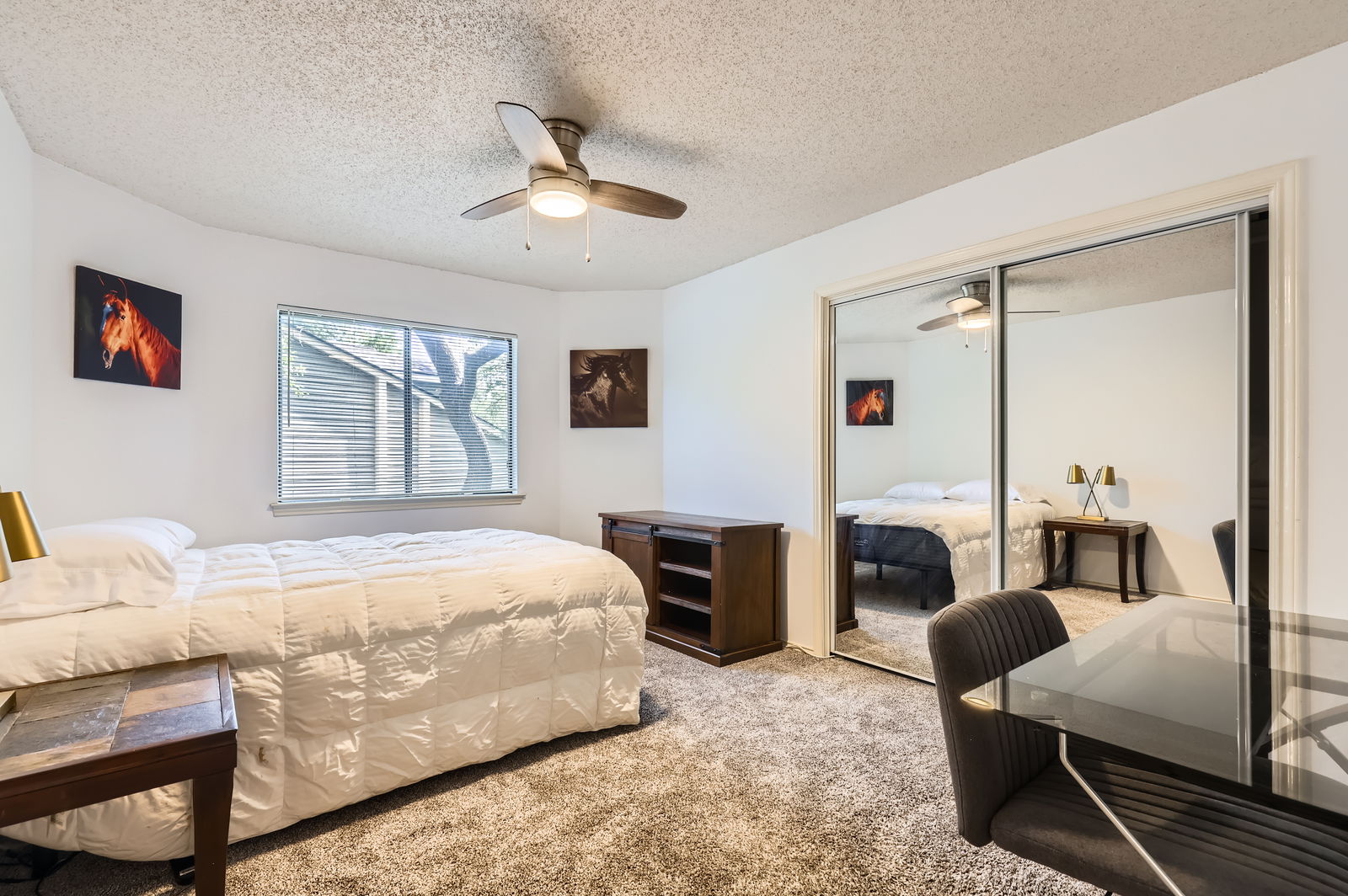 4513 Sidereal Drive Austin, TX 78727 - Photo 26 of 38 Bedroom 1 upstairs with carpet, a closet with mirrored doors, and ceiling fan.
