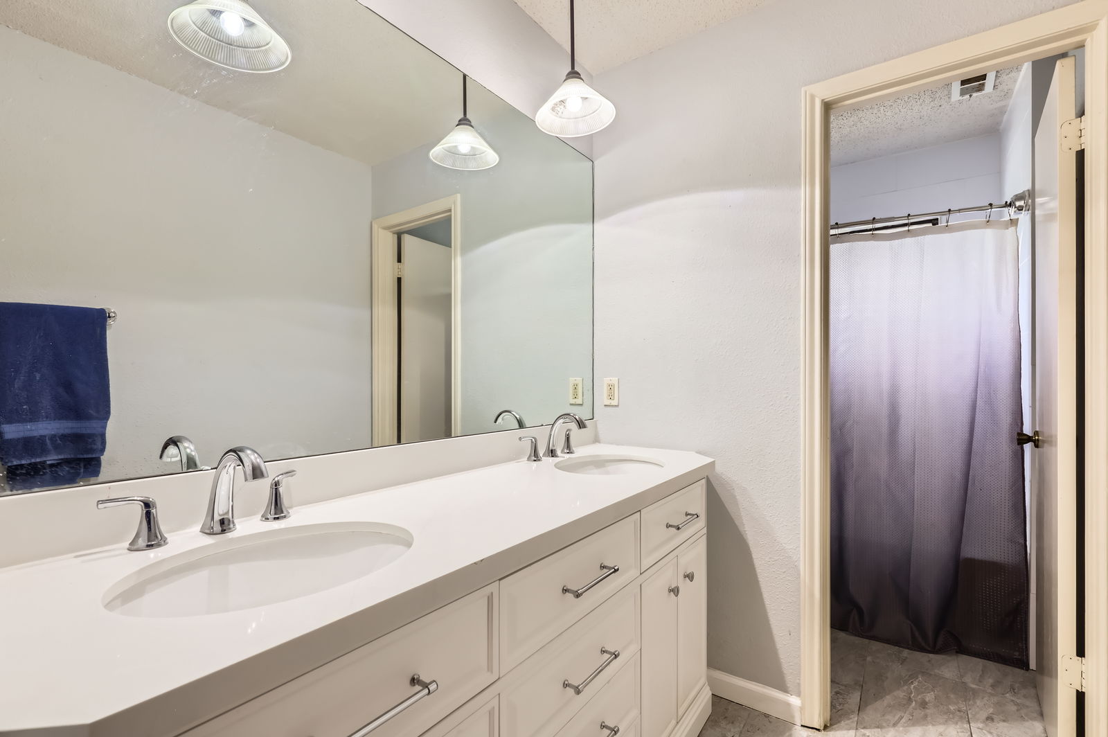 4513 Sidereal Drive Austin, TX 78727 - Photo 29 of 38 a bathroom with a double vanity sink mirror and double