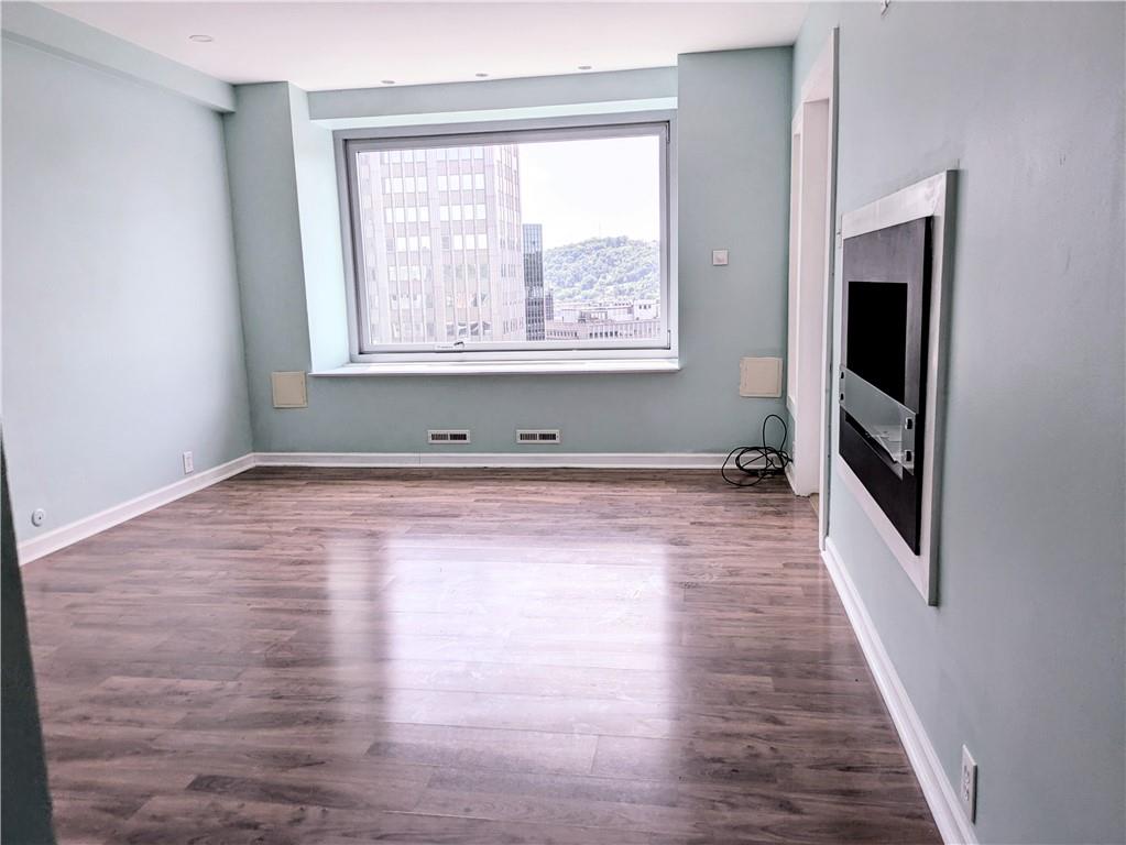320 Fort Duquesne Boulevard, Unit 24M Pittsburgh, PA 15222 - Photo 26 of 40 a view of empty room with wooden floor and fan